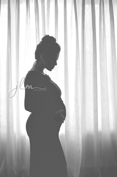 this is an image from a maternity session of an expecting long island mother in her own home 