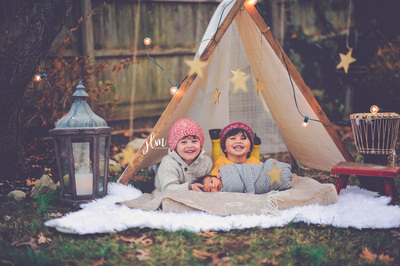this is an outdoor christmas mini session of little boys in a teepee on long island new york 