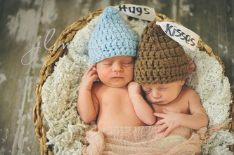 this is a picture of twins in a basket from a newborn studio photo session in long island new york 