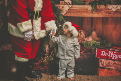 this is a little boy with santa at a christmas mini photo session 
